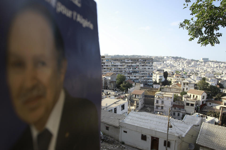 A portrait of former Algerian President Abdelaziz Bouteflika is pictured on the heights of Algiers, Saturday, Sept. 18, 2021. Algeria's leader declared a three-day period of mourning starting Saturday for former President Abdelaziz Bouteflika, whose 20-year-long rule, riddled with corruption, ended in disgrace as he was pushed from power amid huge street protests when he decided to seek a new term. Bouteflika, who had been ailing since a stroke in 2013, died Friday at 84. (AP Photo/Fateh Guidoum)