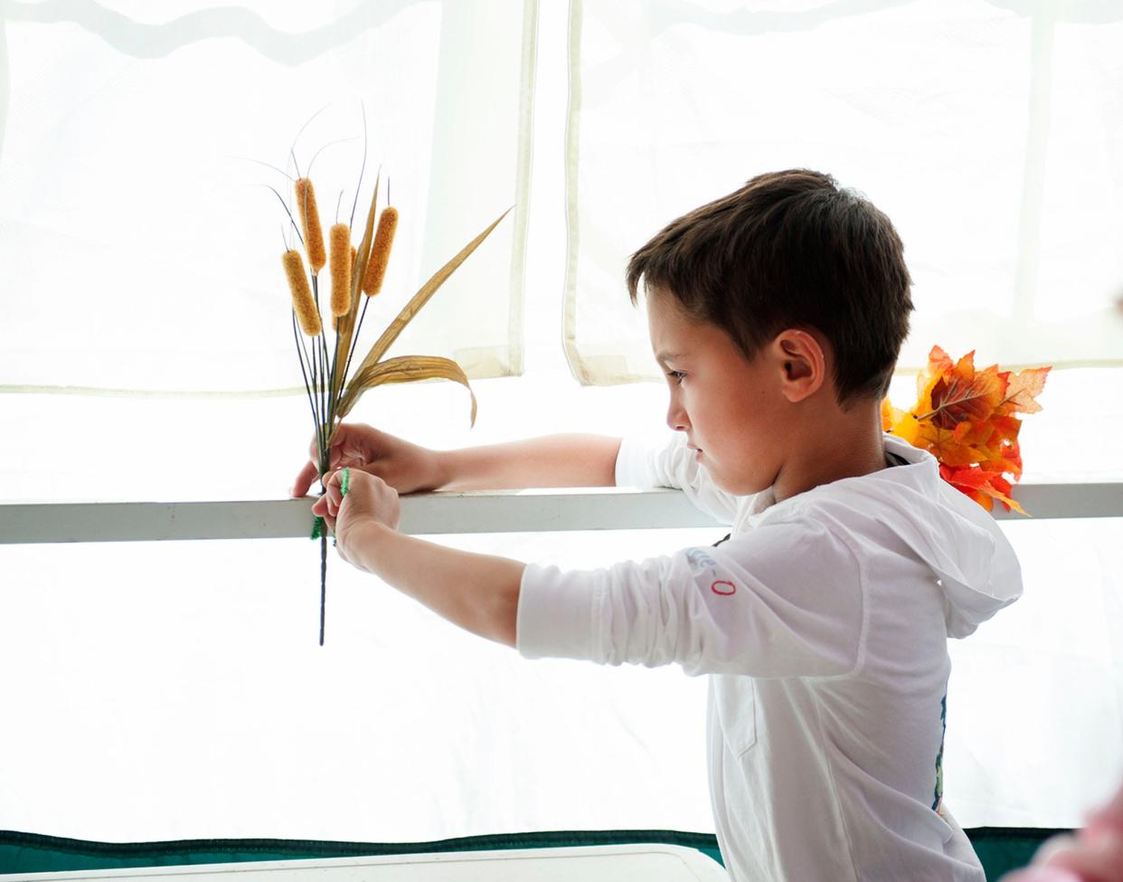 Palm Beach Synagogue Hebrew school student Asher Isaacs, 7, decorates the Sukkah, an outdoor structure, for Sukkot Sept. 19, 2021 in Palm Beach. Pensacola community members are invited for a similar event on Oct. 13 in Pensacola.