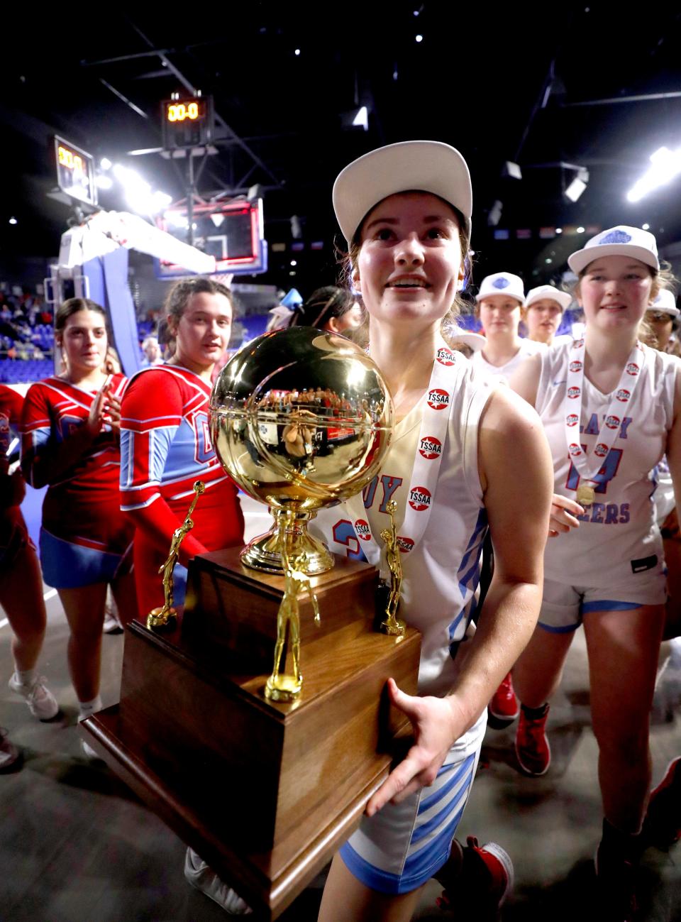 Gibson County's Micah Hart (3) brings the the Class 2A TSSAA Girls Basketball State Championship trophy to the stands after defeating Loretto during the TSSAA 2024 Class 2A State Girls' Basketball Championship game on Saturday March 9, 2024.