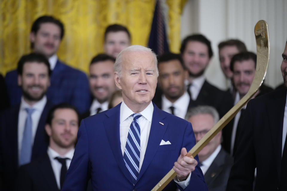 President Joe Biden speaks while holding a hockey stick during an event to celebrate the Vegas Golden Knights in their 2023 Stanley Cup victory in the East Room of the White House, Monday, Nov. 13, 2023, in Washington. (AP Photo/Andrew Harnik)