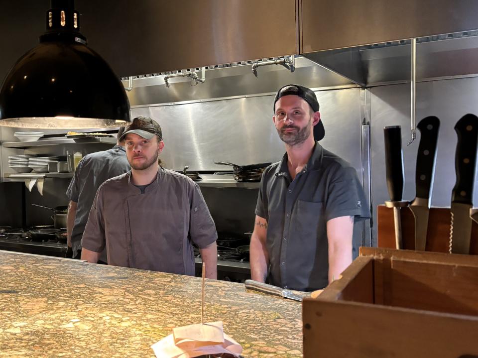 Chef Jonathan McAuley (right) is the chef de cuisine at Port Land Grille restaurant in Lumina Station.