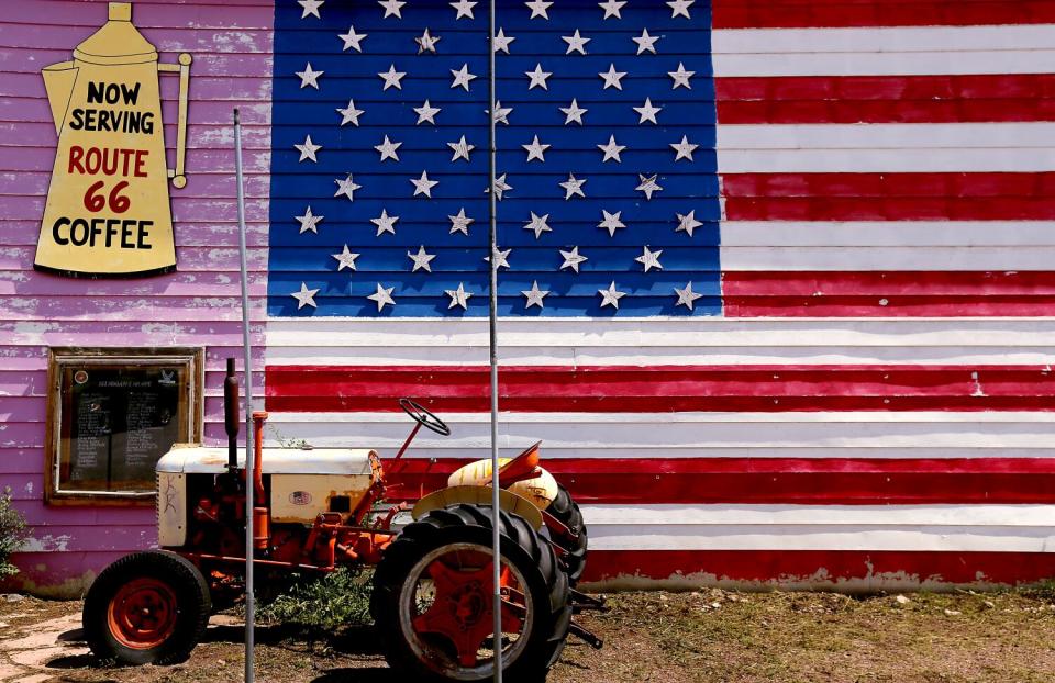 A vintage tractor is parked along Route 66 in Seligman, located near the California-Arizona border.