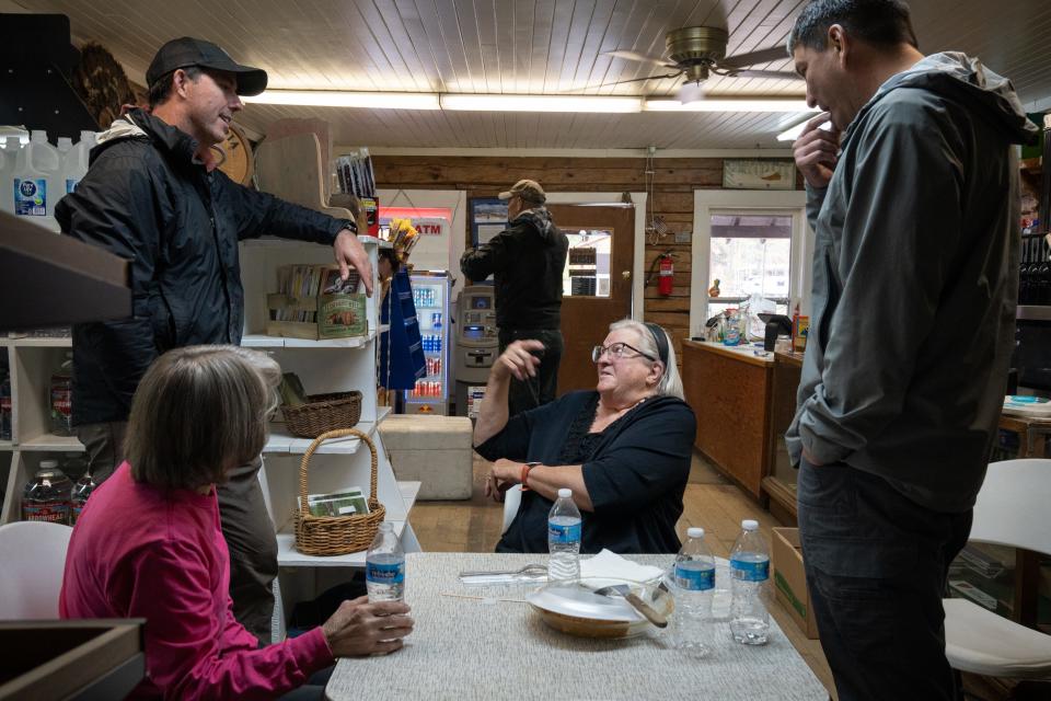 Diana Bryant (center) talks with Wesley Keller (left, Watershed Division project leader for the Nez Perce Tribe) and Emmit Taylor Jr. (right, Watershed Division Director for the Nez Perce Tribe), Sept. 27, 2023, in the Yellow Pine General Store, Idaho.
