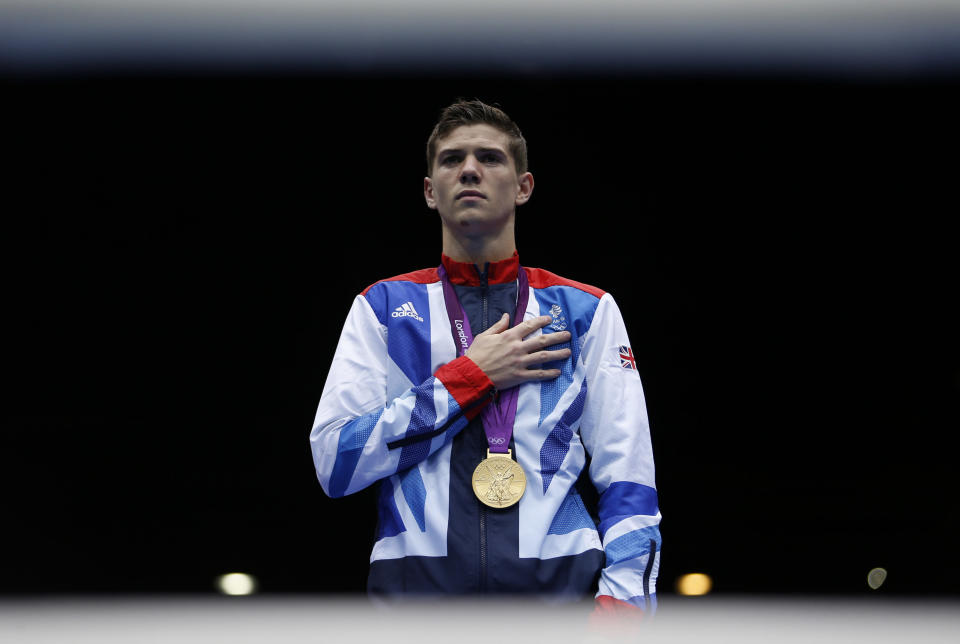 Luke Campbell of Britain stands with his gold medal for the playing of the national anthem during the presentation ceremony for the Men's Bantam (56kg) boxing competition at the London Olympics August 11, 2012. REUTERS/Damir Sagolj (BRITAIN - Tags: SPORT BOXING OLYMPICS) 