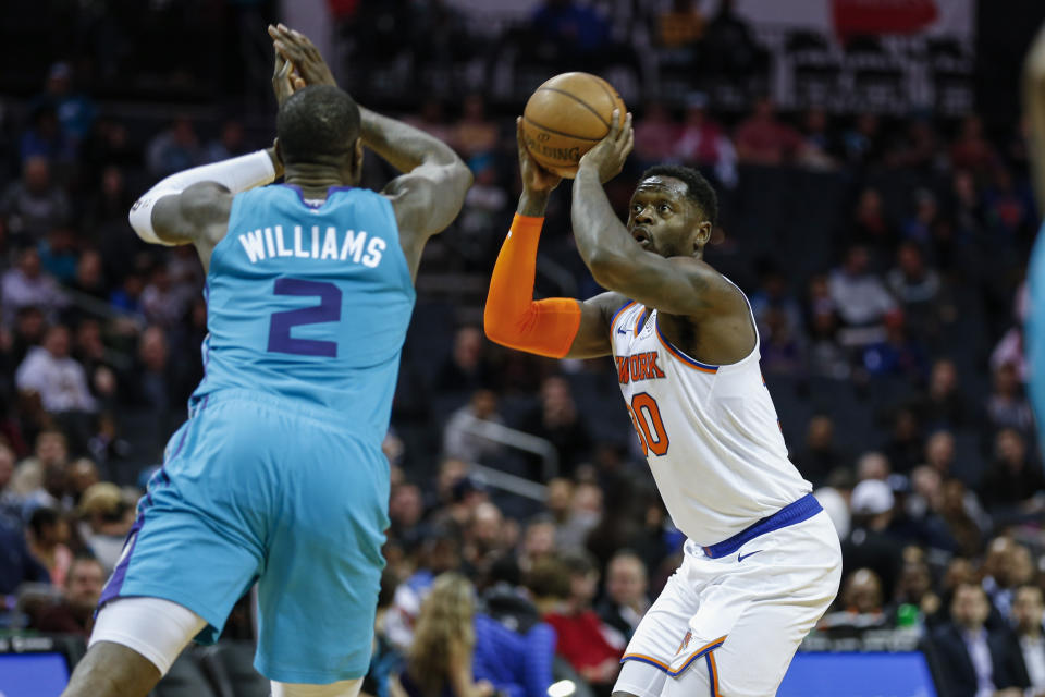 New York Knicks forward Julius Randle, right, shoots over Charlotte Hornets forward Marvin Williams in the second half of an NBA basketball game in Charlotte, N.C., Tuesday, Jan. 28, 2020. Charlotte won 97-92. (AP Photo/Nell Redmond)