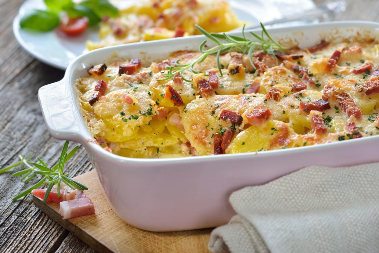 Hearty potato gratin with parmesan cheese, cream and delicious cured bacon from South Tyrol freshly served from the oven