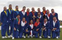 Golf - 2018 Ryder Cup at Le Golf National - Guyancourt, France - September 30, 2018 - Team Europe captain Thomas Bjorn and his team pose with the trophy after winning the Ryder cup REUTERS/Paul Childs