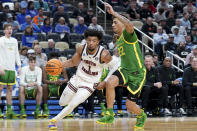 South Carolina's Jacobi Wright (1) drives around Oregon's Jadrian Tracey (22) during the first half of a college basketball game in the first round of the NCAA men's tournament Thursday, March 21, 2024, in Pittsburgh. (AP Photo/Matt Freed)