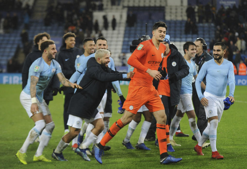 Manchester City's goalkeeper Arijanet Muric, centre celebrates in font of their fans teammates after they won the English League Cup quarterfinal soccer match at the King Power stadium in Leicester, England, Tuesday, Dec.18, 2018. Manchester City won 3-1 in a penalty shoot out after the match ended in a 1-1 draw in normal time. (AP Photo/Rui Vieira)