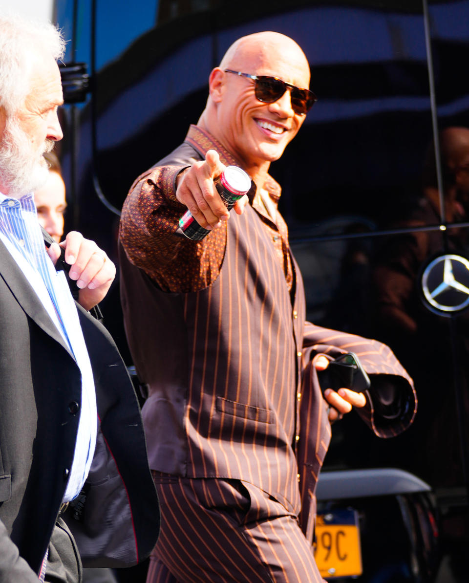 the rock pointing at fans as he walks outside