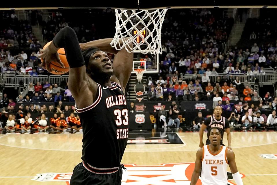 Oklahoma State's Moussa Cisse dunks the ball against Texas during the second round of the Big 12 Conference Tournament on March 9 in Kansas City, Mo.