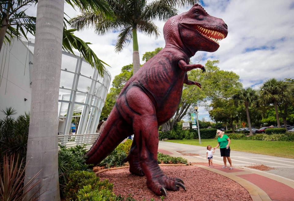 Lisa Langan and granddaughter Sammy take a look at a 28-foot-tall Tyrannosaurus Rex named Rosie that stands outside the Cox Science Center and Aquarium in West Palm Beach.