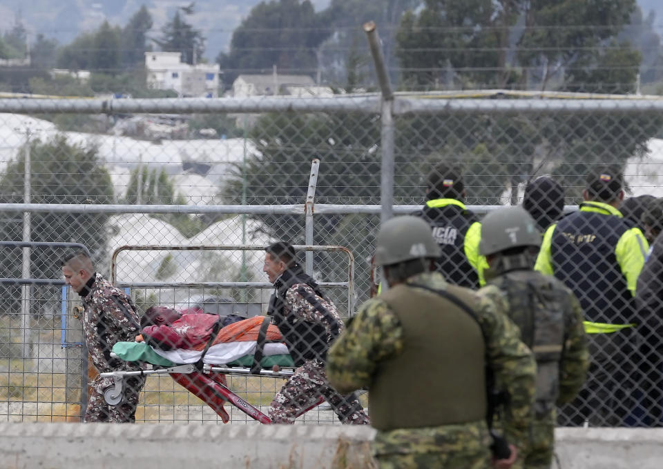 An injured inmate is evacuated in a gurney after a deadly prison riot in Latacunga, Ecuador, Tuesday, Oct. 4, 2022. A clash between inmates armed with guns and knives inside the prison has left at least 15 people dead and 20 injured. (AP Photo/Dolores Ochoa)