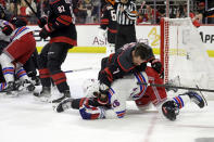 Carolina Hurricanes defenseman Dmitry Orlov (7) wrestles New York Rangers left wing Jimmy Vesey (26) to the ice as the teams got into a scuffle during the first period in Game 3 of an NHL hockey Stanley Cup second-round playoff series Thursday, May 9, 2024, in Raleigh, N.C. Both players were penalized on the play. (AP Photo/Chris Seward)