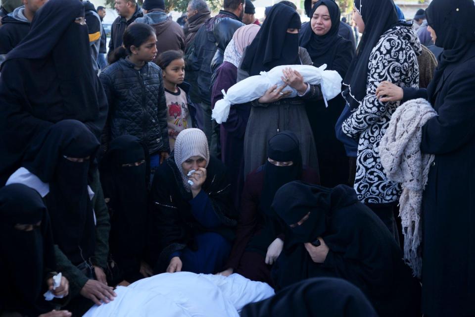 Palestinians mourn their relatives killed in the Israeli bombardment of the Gaza Strip in Deir al Balah, Monday, Feb. 5, 2024.