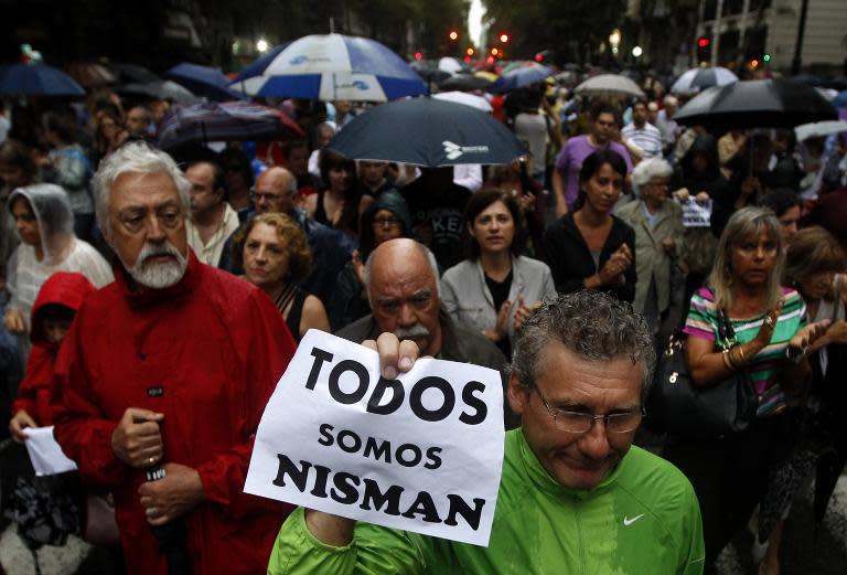 A man holds a placard reading "We All Are Nisman" during the "Marcha del silencio" (Silence March) called by Argentine prosecutors in memory of their late colleague Alberto Nisman in Buenos Aires, February 18, 2015