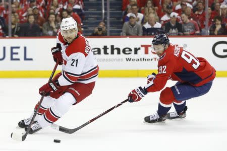 Apr 20, 2019; Washington, DC, USA; Carolina Hurricanes right wing Nino Niederreiter (21) skates with the puck as Washington Capitals center Evgeny Kuznetsov (92) chases in the first period in game five of the first round of the 2019 Stanley Cup Playoffs at Capital One Arena. Mandatory Credit: Geoff Burke-USA TODAY Sports