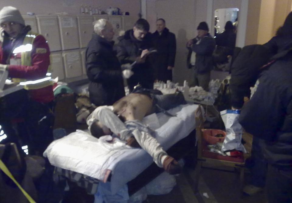 The body of an unidentified man lies in a building near the street where clashes took place in Kiev, Ukraine, on Wednesday, Jan. 22, 2014. Two people have died in clashes between protesters and police in the Ukrainian capital Wednesday, according to medics on the site, in a development that will likely escalate Ukraine's two month-long political crisis. (AP Photo/Yuras Karmanau)