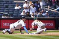 New York Yankees Gary Sanchez (24) and Oakland Athletics third baseman Matt Chapman (26) look toward the third base umpire after Sanchez advanced to third but overran the base on a throw home after hitting a two-run double during the sixth inning of a baseball game, Sunday, June 20, 2021, at Yankee Stadium in New York. Sanchez was safe after a review.(AP Photo/Kathy Willens)
