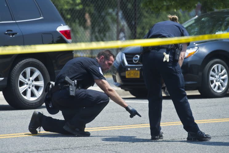 Crime scene investigators search for evidence at the scene of a multiple shooting in Alexandria, Va., on June 14, 2017. House Majority Whip Steve Scalise of Louisiana and four others were shot during a congressional baseball practice. (Photo: AP/Cliff Owen)