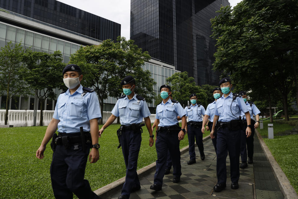 Police officers patrol outside the Central Government Offices in Hong Kong, Friday, May 22, 2020. Hong Kong's pro-democracy lawmakers have sharply criticized China's move to take over long-stalled efforts to enact national security legislation in the semi-autonomous territory. They say it goes against the "one country, two systems" framework that promises the city freedoms not found on the mainland. (AP Photo/Kin Cheung)