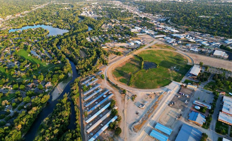 An aerial view of the former horse-racing track and stables next to Expo Idaho looking southeast. The Boise River Greenbelt can be seen at center left, behind the former horse stables.