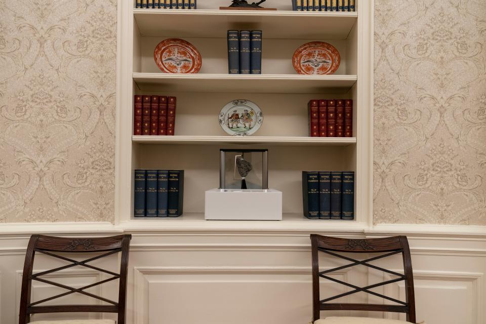 A rock from the moon on the center shelf in the Oval Office after it was newly redecorated for the first day of President Joe Biden’s administrationAP