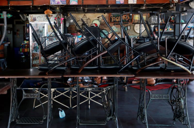 People sleep in a closed restaurant following the coronavirus disease (COVID-19) outbreak in Pattaya