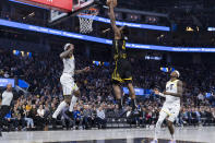 Golden State Warriors forward Andrew Wiggins, center, shoots in front of Utah Jazz guard Jordan Clarkson, left, and center Jarred Vanderbilt (8) during the first half of an NBA basketball game in San Francisco, Friday, Nov. 25, 2022. (AP Photo/John Hefti)