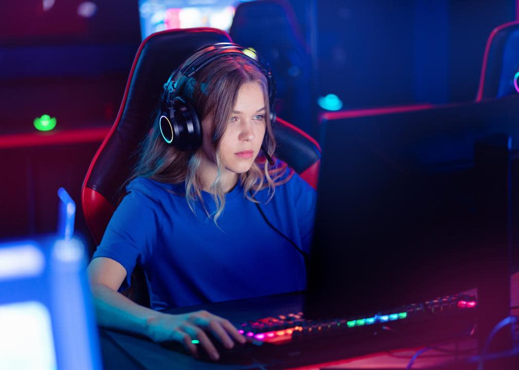 Young female gamer playing an online video game.
