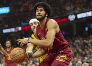 Cleveland Cavaliers' Jarrett Allen, right, is fouled by Indiana Pacers' Andrew Nembhard, center left, during the first half of an NBA basketball game in Cleveland, Friday, April 12, 2024. (AP Photo/Phil Long)