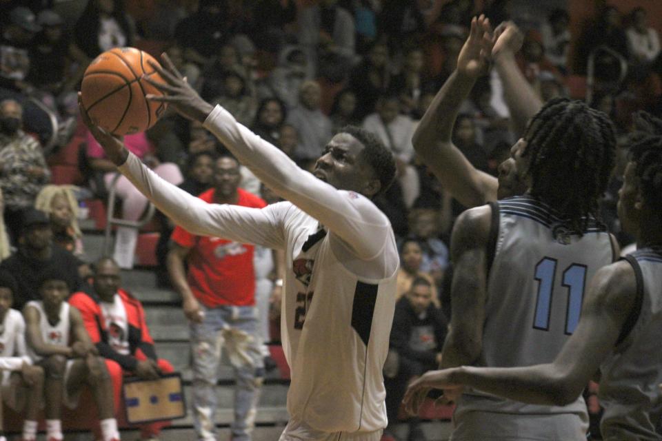 Jackson forward Ronald Durham (21) pulls down a rebound in front of Ribault forward Kalvin Gilbert Jr. (11) during the Northwest Christmas Tournament final.