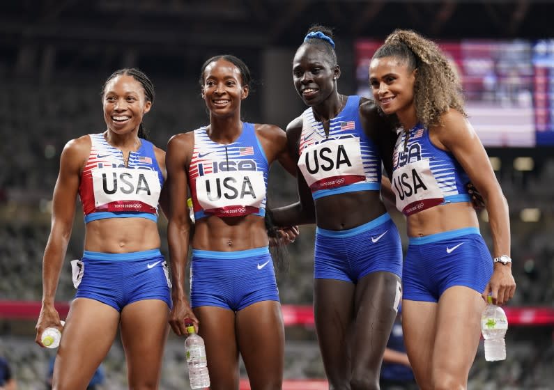 The United States team of Allyson Felix, Dalilah Muhammad, Athing Mu.