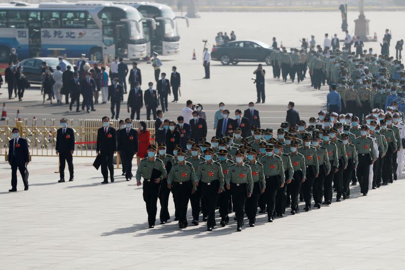 Delegates wearing face masks following the coronavirus disease (COVID-19) outbreak arrive to the Great Hall of the People before the opening session of the National People's Congress (NPC) in Beijing