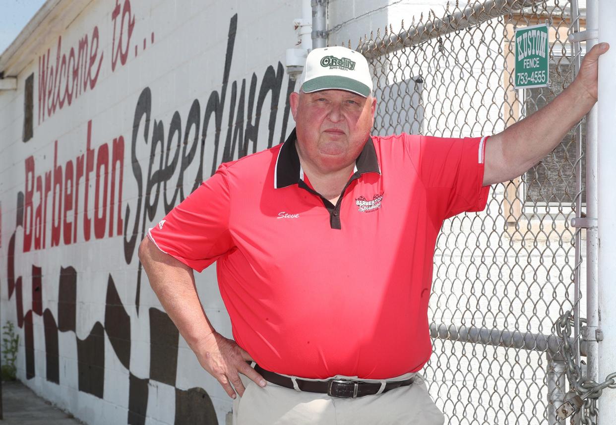 Steve Brookens, who worked at Barberton Speedway for 47 years, stands outside the chain-locked gate of the closed racetrack.