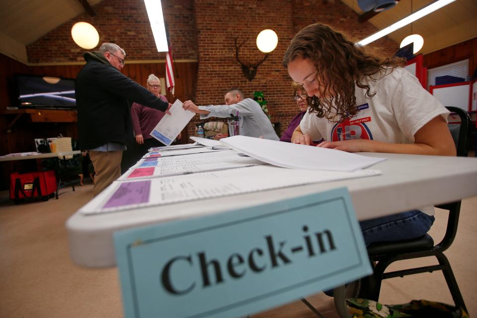 A voter checks in at the Buttonwood Warming House polling station to vote in the Super Tuesday Presidential Primary election on March 5, 2024 in New Bedford.