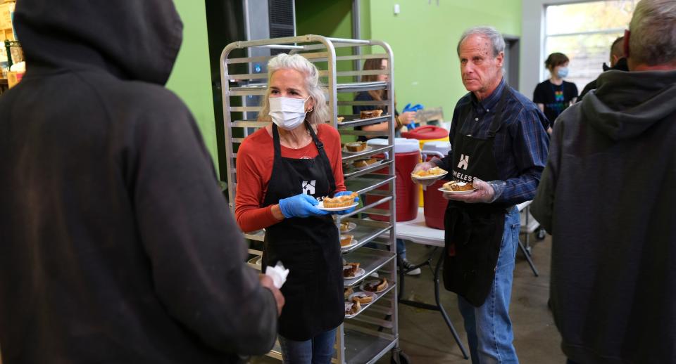 Nancy and Tim Delpha hand out pie Wednesday, Nov. 23, 2022, during a Thanksgiving meal at the Homeless Alliance.