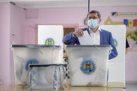 The interim leader of the Action and Solidarity Party, Igor Grosu prepares to cast his vote in a snap parliamentary election, in Chisinau, Moldova, Sunday, July 11, 2021. Moldovan citizens vote in a key snap parliamentary election that could decide whether the former Soviet republic fully embraces pro-Western reform or prolongs a political impasse with strong Russian influence. (AP Photo/Aurel Obreja)