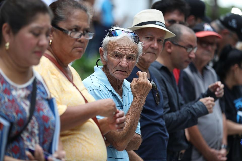 <p>People wait for the hearse carrying Miami Marlins pitcher Jose Fernandez to pass in front of the Marlins baseball stadium on September 28, 2016 in Miami, Florida. Mr. Fernandez was killed in a weekend boat crash in Miami Beach along with two friends. (Photo by Joe Raedle/Getty Images) </p>