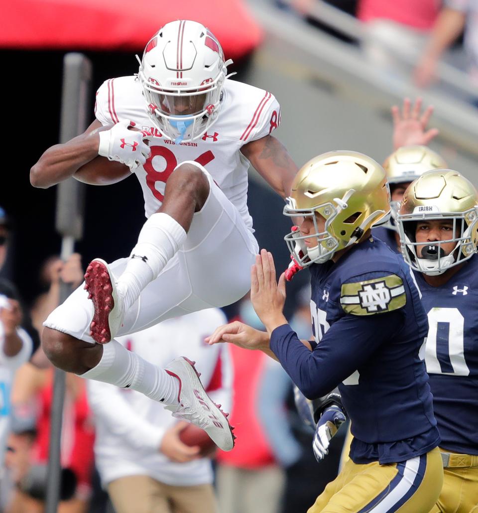 Wisconsin Badgers wide receiver Devin Chandler (86) tries to hurdle Notre Dame Fighting Irish place kicker Jonathan Doerer (39) as he is knocked out of bounds on a kick off return during their football game Saturday, Sept. 25, 2021, at Soldier Field in Chicago, Ill.