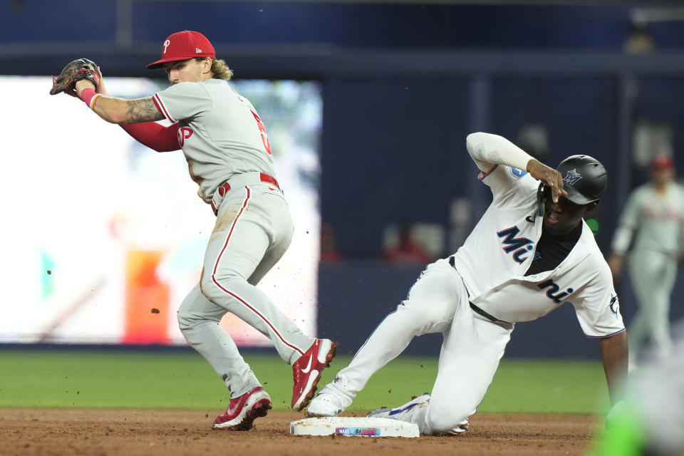 Philadelphia Phillies second baseman Bryson Stott (5) tags Miami Marlins' Jesus Sanchez on second base during the first inning of a baseball game, Tuesday, Aug. 1, 2023, in Miami. (AP Photo/Marta Lavandier)