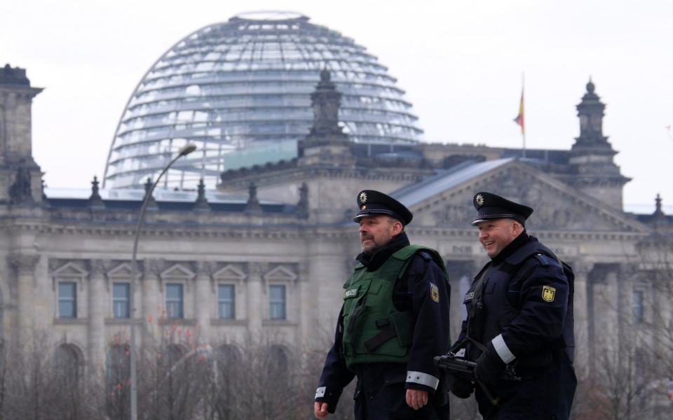 German police patrol outside Chancellery near Reichstag building in Berlin - THOMAS PETER/Reuters