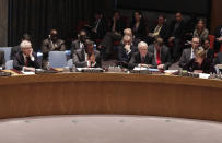 Russian Federation Ambassador Vitaly Churkin, left, listens as U.S. Ambassador Samantha Power, right, addresses the United Nations Security Council, at UN headwquarters Friday, May 2, 2014. The U.N. Security Council is meeting in emergency session on Ukraine after Russia called for a public meeting on the growing crisis there. (AP Photo/Richard Drew)