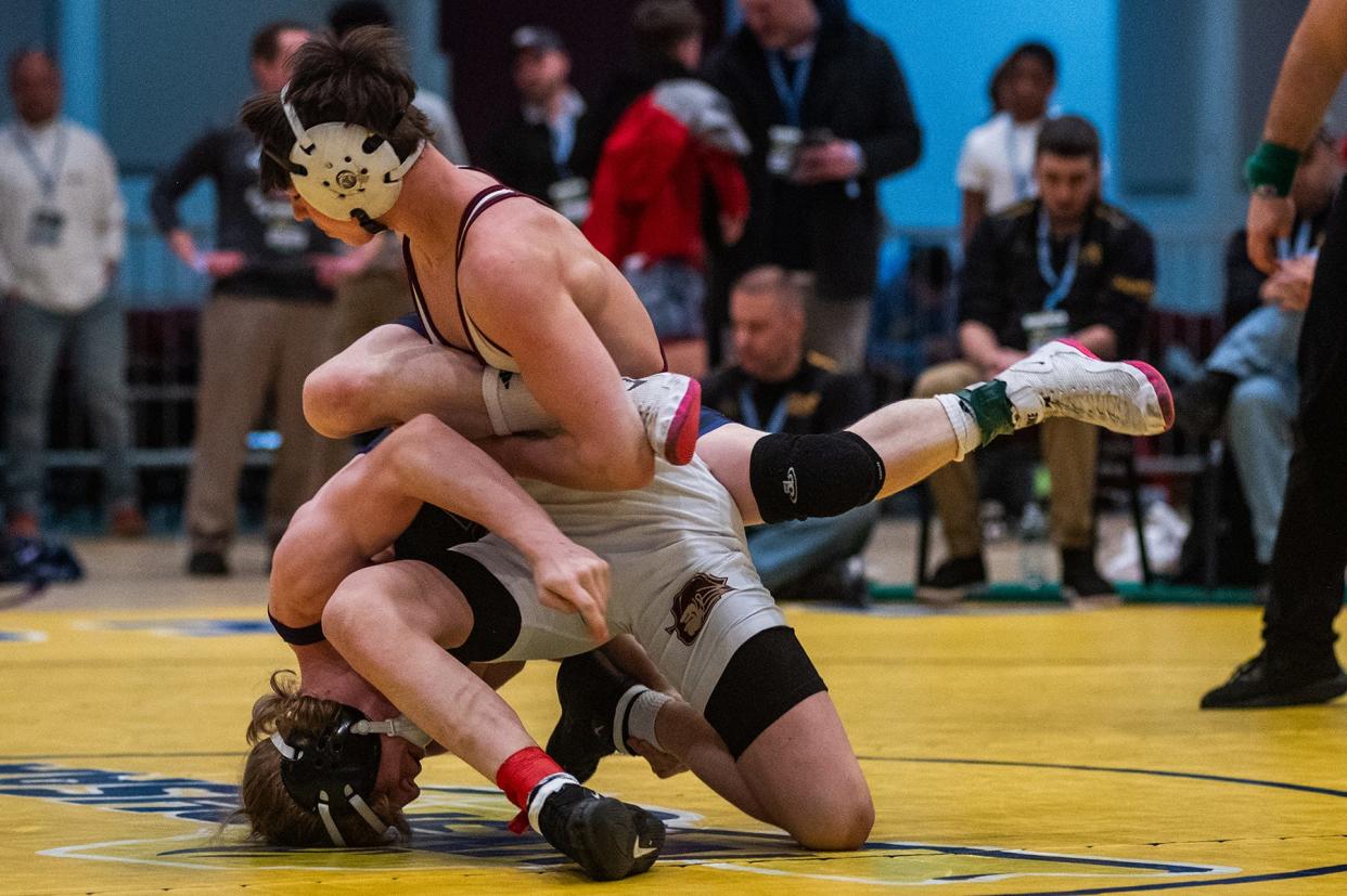 Arlington's Dillon Arrick, front, wrestles Clarkstown North Sr High School's Dylan LaRocco in the 124 pound weight class during the Section 1 division 1 wrestling championship in White Plains, NY on Sunday, February 11, 2024.