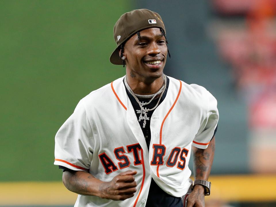 Rap Artist Travis Scott reacts after throwing the first pitch before the game between the Houston Astros and the Oakland Athletics at Minute Maid Park on April 6, 2019 in Houston, Texas.