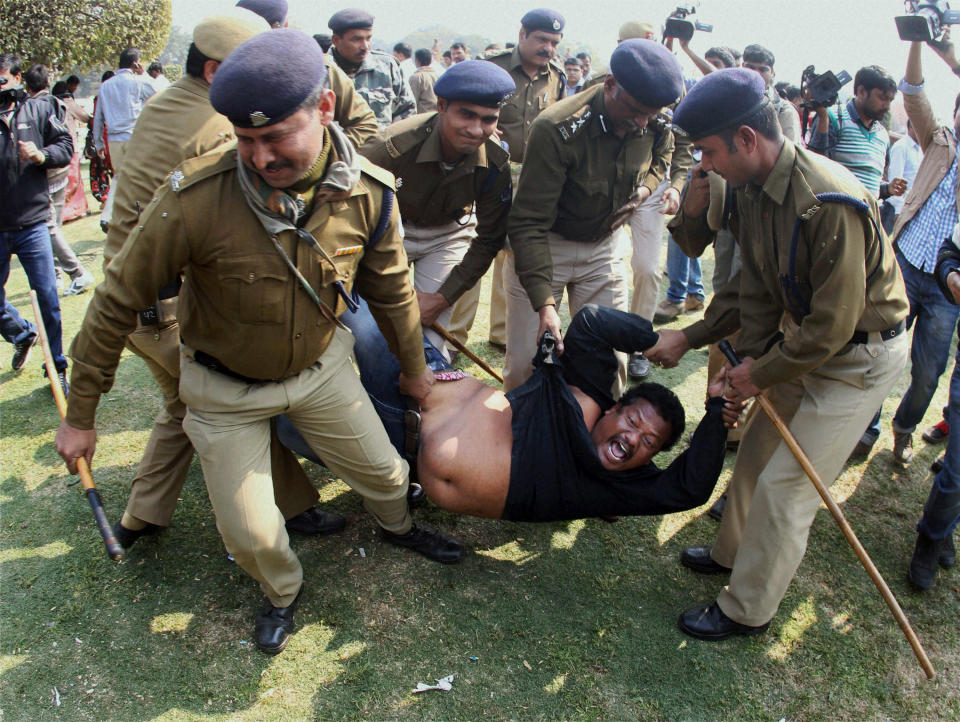 Indian policemen detain a supporter of the creation of a separate state of Telangana out of existing Andhra Pradesh state as he shouts slogans during a protest outside Vijay Chowk square in New Delhi, India, Thursday, Feb. 13, 2014. Congress party lawmaker L. Rajagopal from Andhra Pradesh sprayed pepper spray inside India's Parliament on Thursday from the main speaking zone, creating chaos that left his colleagues coughing and crying as they were ushered from the hall, in a protest over a long-contentious proposal to create a new southern state. (AP Photo)