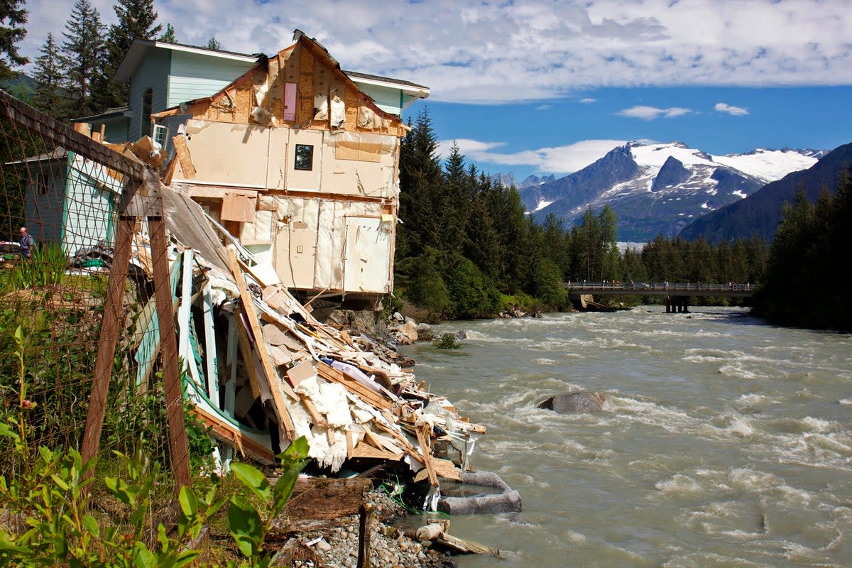 Debris from a home that partially fell into the Mendenhall River (AP)