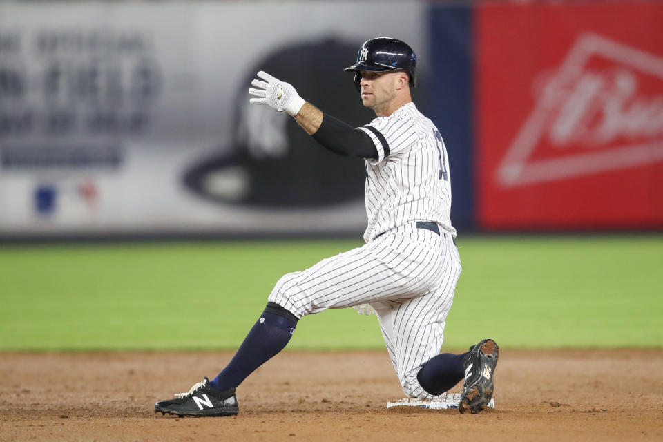 FILE - In this Sept. 19, 2019, file photo, New York Yankees' Brett Gardner gestures from second base after hitting an RBI double during the sixth inning of the teams' baseball game against the Los Angeles Angels in New York. Gardner is returning to the Yankees for a 14th season. The 37-year outfielder and New York agreed Friday to a $4 million, one-year contract, a person familiar with the negotiations told The Associated Press. (AP Photo/Mary Altaffer, File)