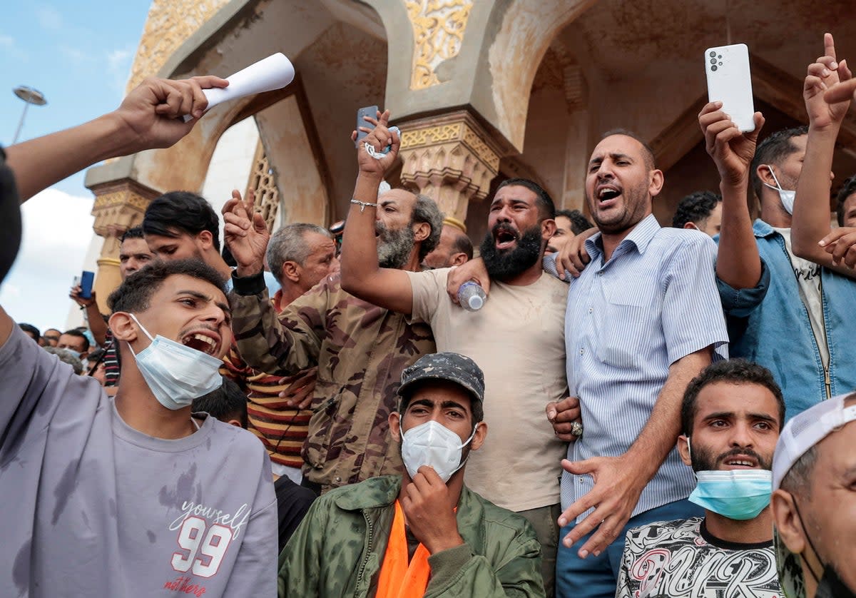 People who survived the deadly storm that hit Libya protest outside the al-Sahaba Mosque in Derna (Reuters)