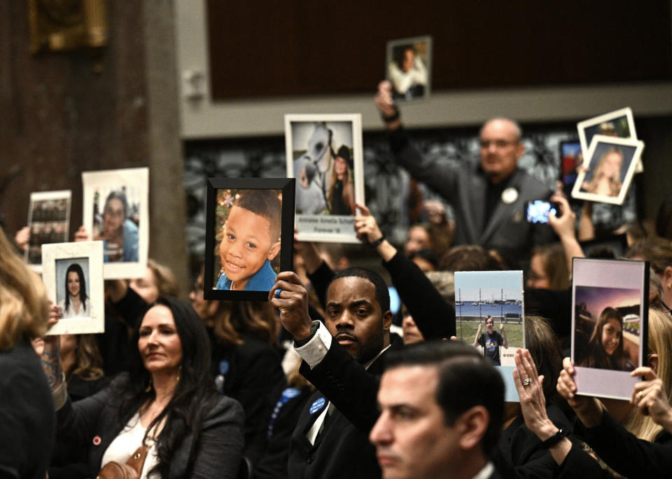 Relatives of victims hold their portraits (Brendan Smialowski   / AFP - Getty Images)